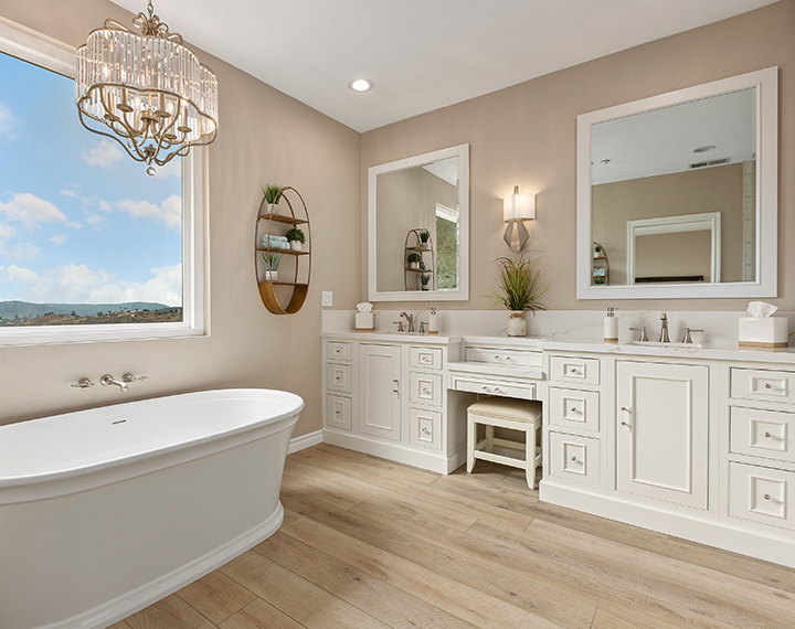 White semi-custom cabinets are used to create a bathroom vanity. The white cabinets house two sinks.