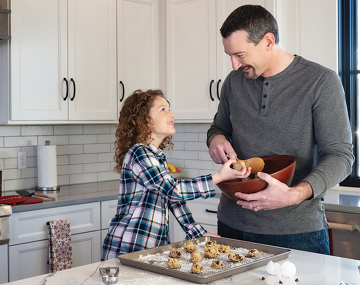 Father and daughter making cookies