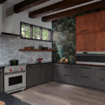 Warm stained and black textured kitchen cabinets