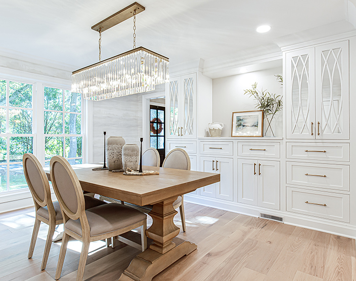 Semi-custom cabinets making up a white dining hutch that stretches a full wall.