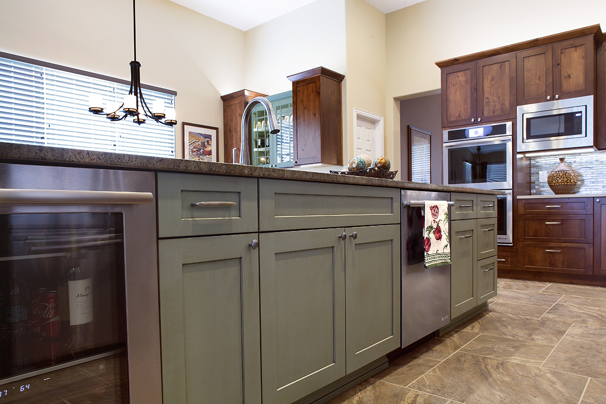 Dark stained and green kitchen cabinets