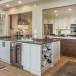 warm stained island and white kitchen cabinets