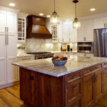 white kitchen cabinets and dark stained island