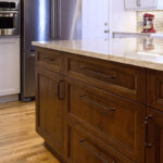 dark stained Island and white kitchen cabinets