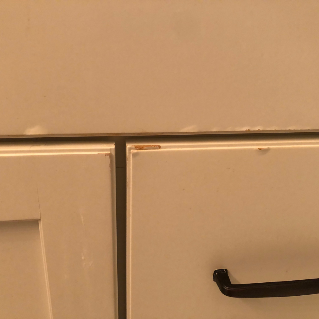 Chipped paint on cabinet door