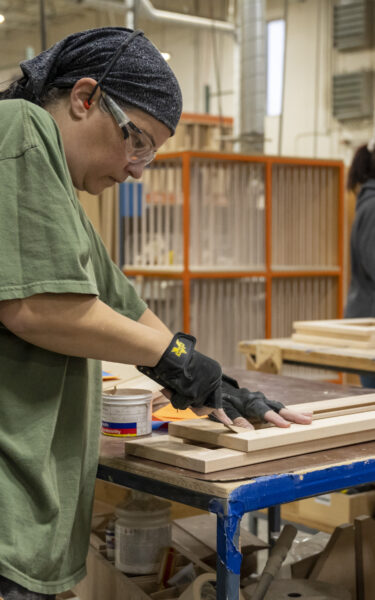 showplace employee working on cabinet in warehouse