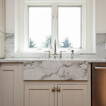 white wooden cabinetry with marbled stone countertops.