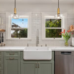 white and green kitchen with tub sink infront of windows