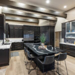 kitchen cabinets in dark brown with black island seating and countertops