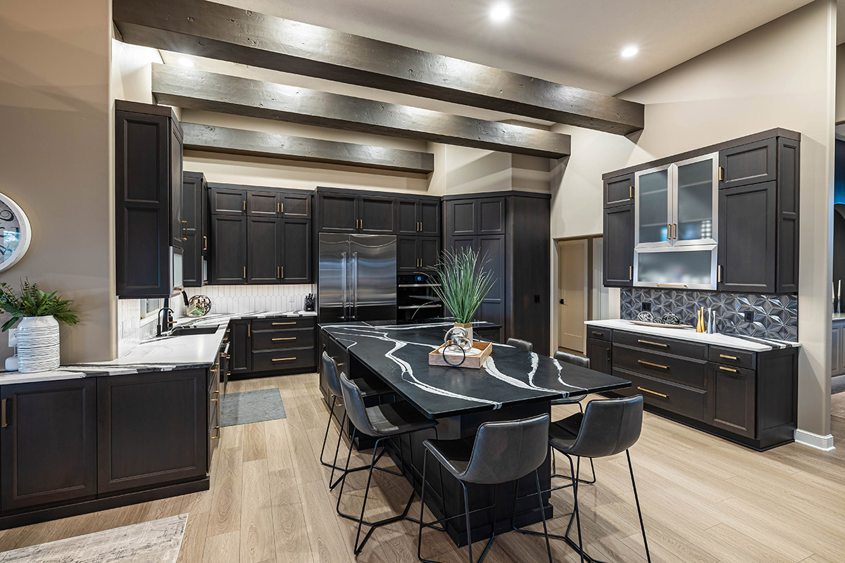 kitchen cabinets in dark brown with black island seating and countertops