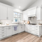 all white kitchen with silver hardware