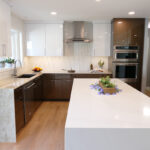 modern kitchen space with glossy white and brown cabinetry, stone island