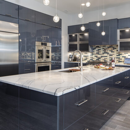 marbled countertops, glossy navy cabinets