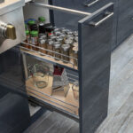 glossy acrylic cabinetry that is open to show a spice drawer and cheese grater.