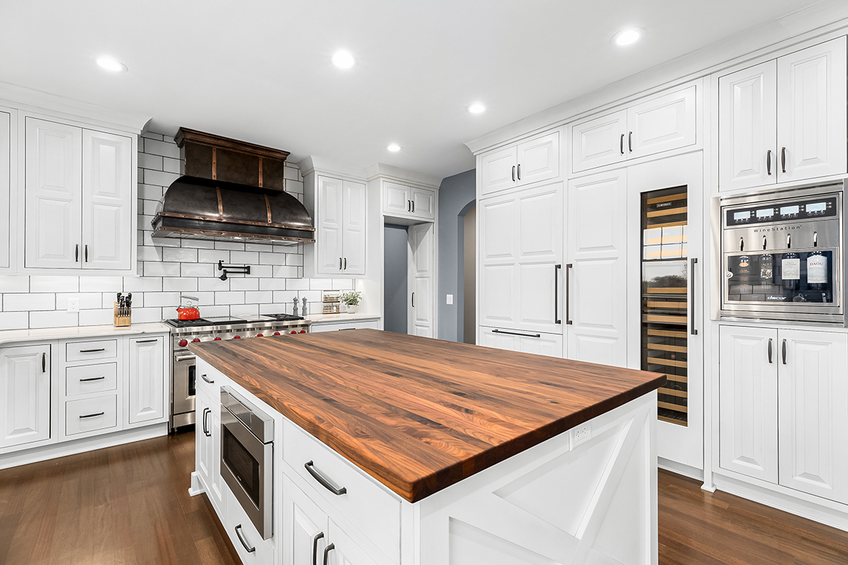 Floor to ceiling pantry is shown here with a glass faced wine fridge. There is also a wine dispenser built into the wall for 4 bottles of wine.