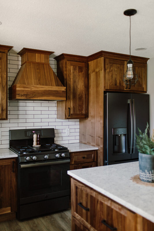 dark walnut kitchen cabinetry with white stone vanity