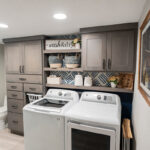 dual purpose bathroom/laundry room with convenient cabinet storage above.