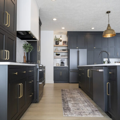 kitchen with black cabinetry and brass accents.