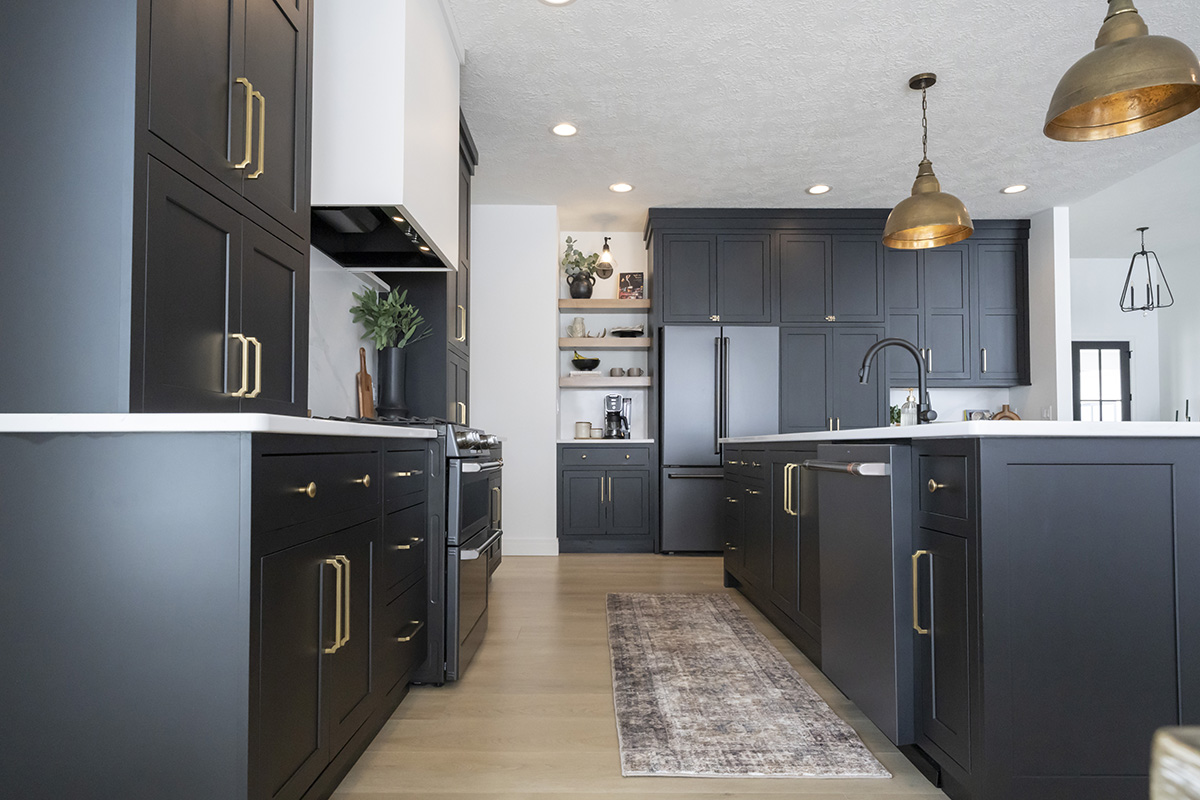kitchen with black cabinetry and brass accents.