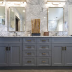 gray bathroom cabinetry with dual sink, multicolored stone vanity