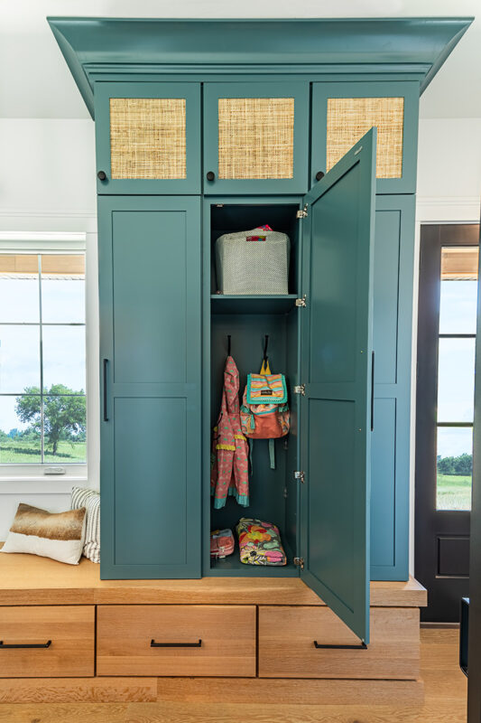 entryway with teal colored closet storage
