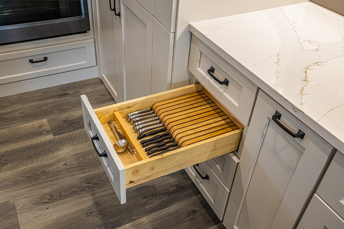 knife drawer inside white kitchen cabinets