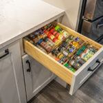 spice drawer inside white kitchen cabinet system