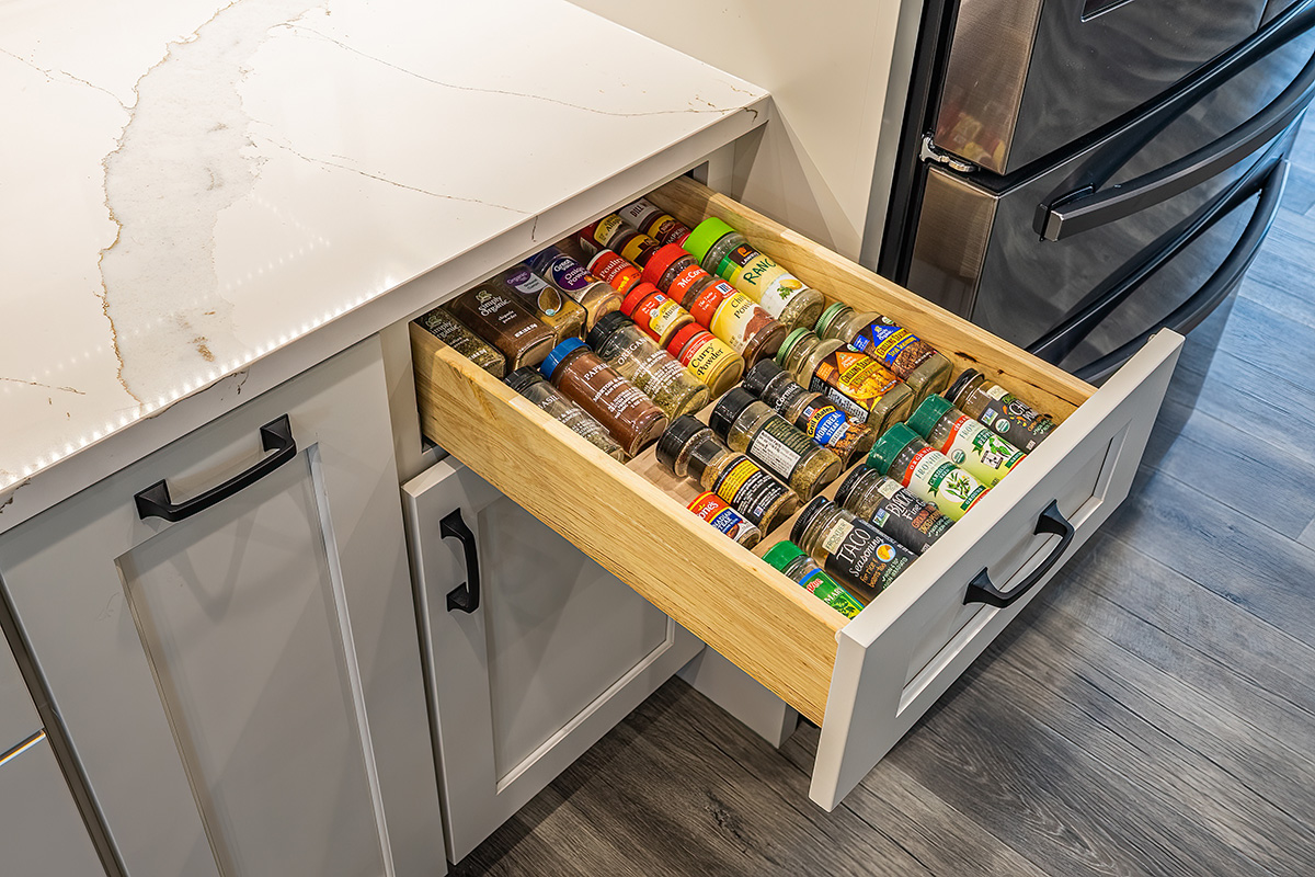 spice drawer inside white kitchen cabinet system