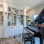 library and piano room with white cabinetry