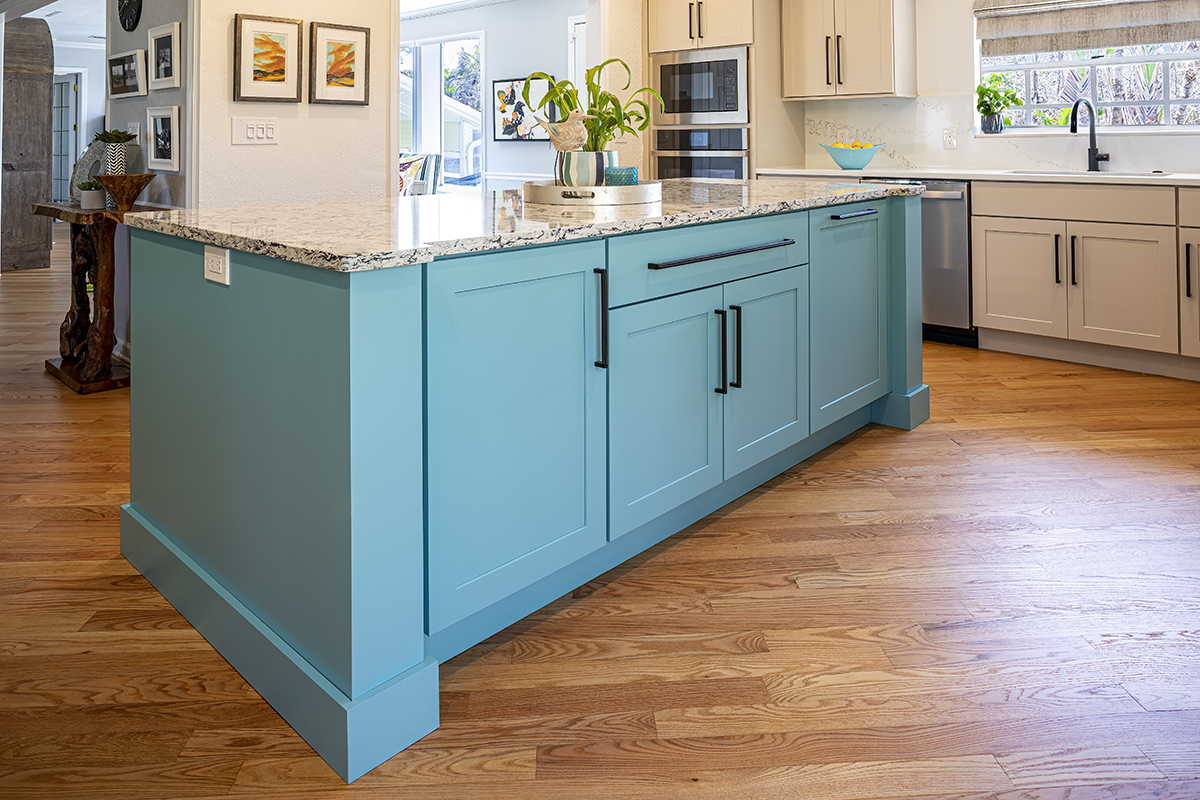 blue island counterspace in the middle of a modern kitchen.