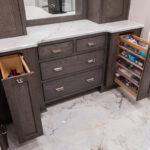 Stained cabinetry in bathroom showing pullout storage accessories