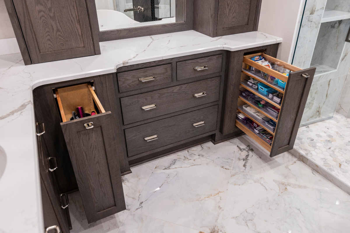 Stained cabinetry in bathroom showing pullout storage accessories