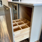 Drawer with partitions to hold wine bottles