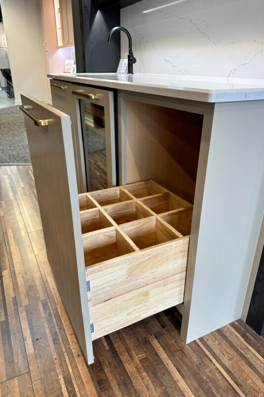 Drawer with partitions to hold wine bottles