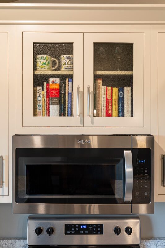 Cookbooks in a cabinet with glass doors