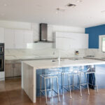 Stained and white acrylic kitchen perimeter with blue acrylic surface island cabinets