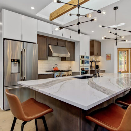 Stained and white painted kitchen cabinets with island.