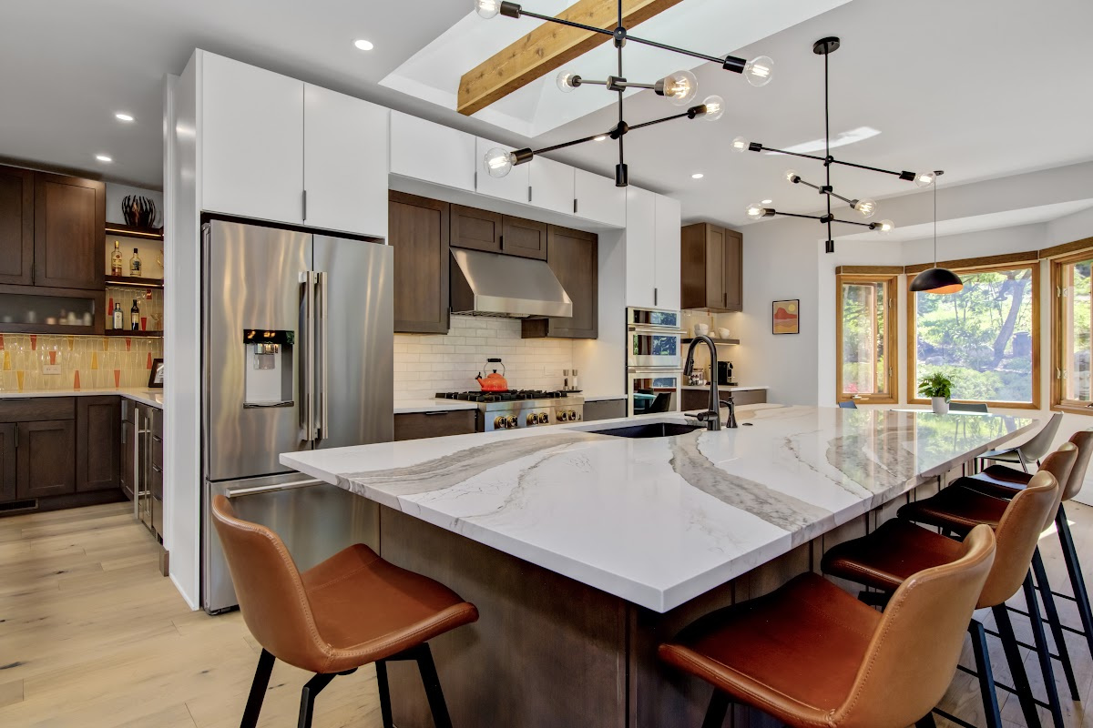 Stained and white painted kitchen cabinets with island.