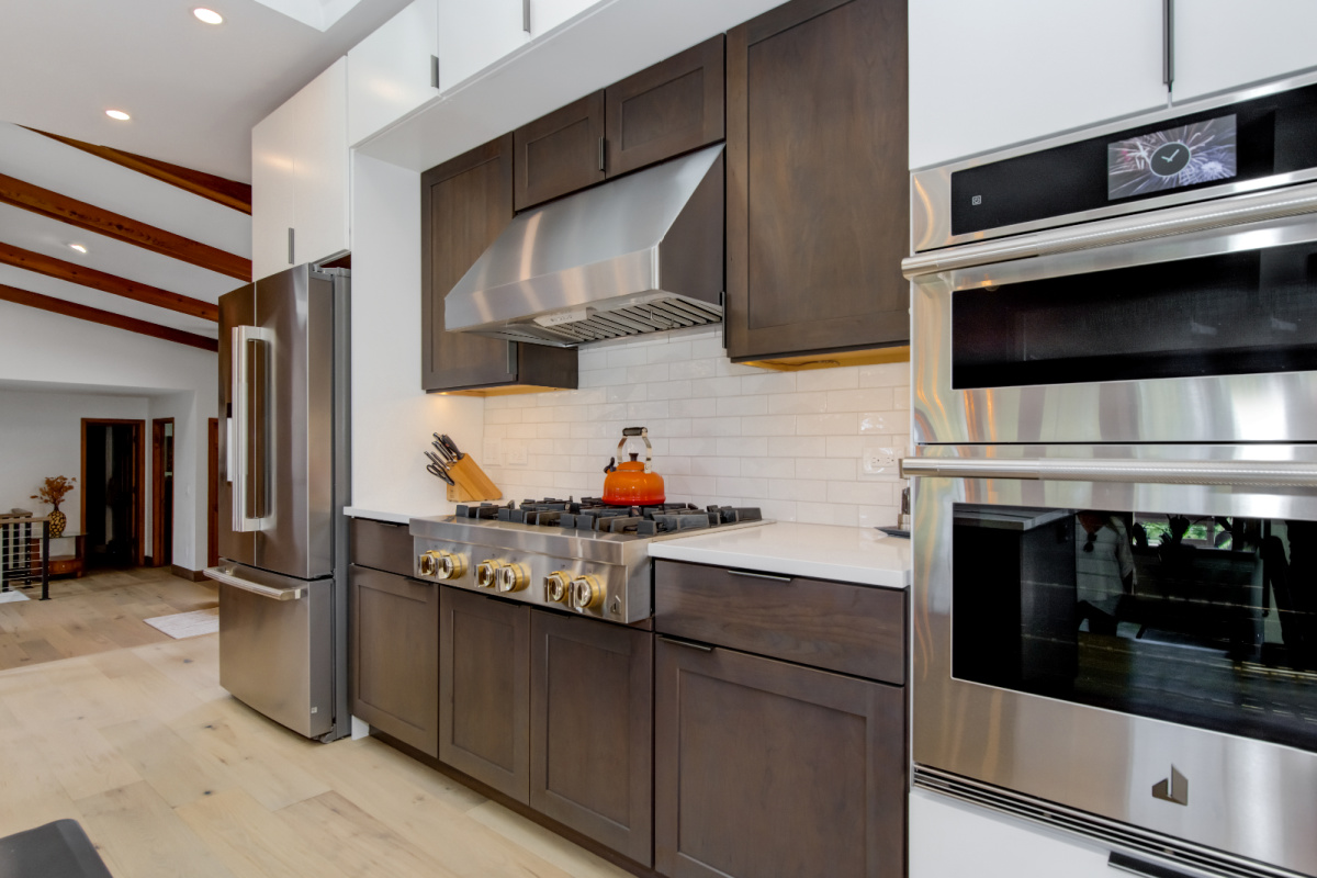 Stained kitchen cabinets with island.