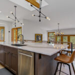 Stained kitchen cabinets with island.