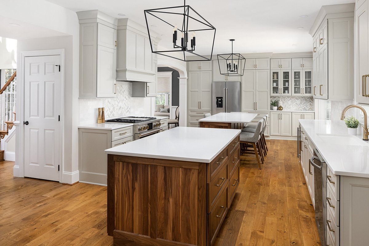 Painted kitchen cabinets with stained double islands