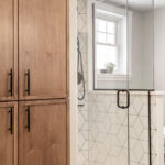 Bathroom with stained vanity and doors to cover laundry space