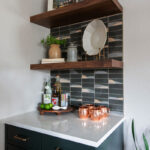 Painted cabinet and stained floating shelves as a small bar area