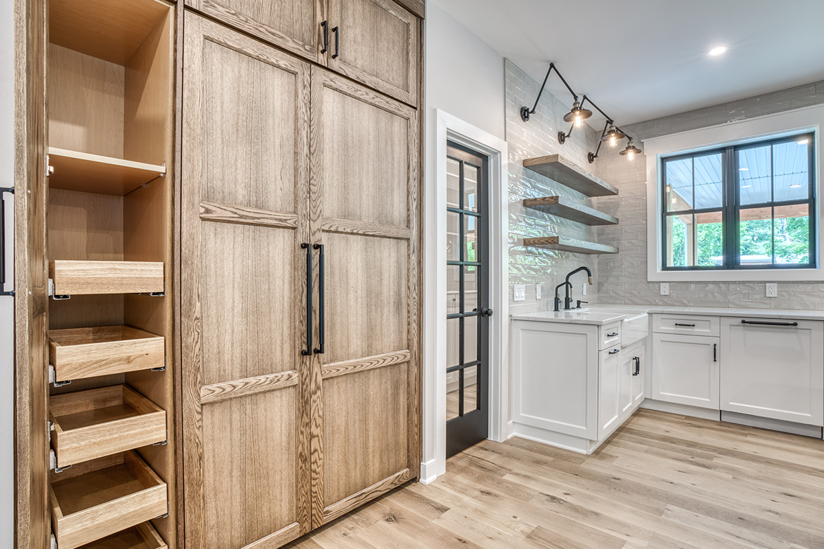 Stained and painted kitchen cabinets featuring paneled refrigerator doors