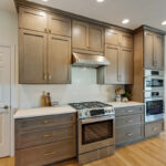 Stained kitchen cabinets with stainless steel appliances