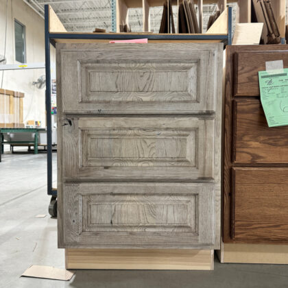 3 drawer base in a warehouse area finished in Montana stain on rustic hickory.