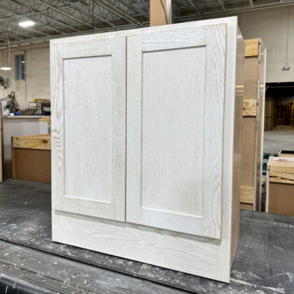 Wall base cabinet with full height doors painted white on Red Oak.