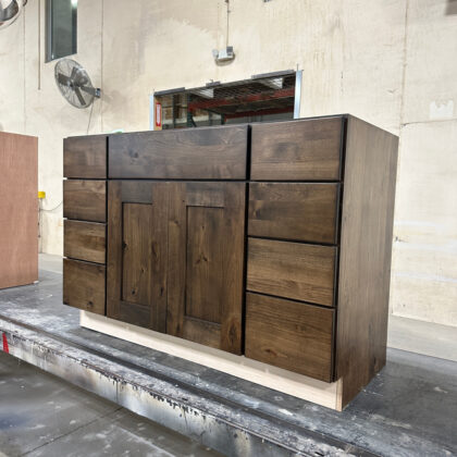 Vanity combination sink base with drawer bases stained in Tawny finish on Rustic Alder.