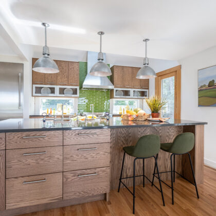 Kitchen with stained cabinets with island seating