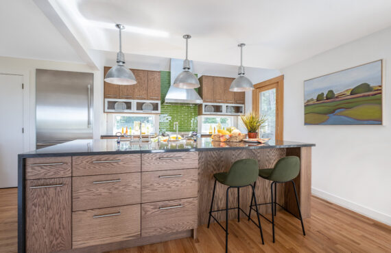 Kitchen with stained cabinets with island seating